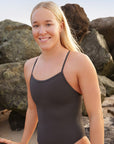 Athlete Ella wears the Airlie fixed back one piece by JAYD Swimwear in the colour carbon. This piece is full coverage and is made to move with you.