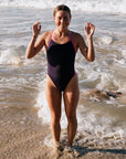 Triathlete Charlotte Derbyshire wearing the IBIZA chlorine resistant one piece designed by JAYD Swimwear in the colour Acai with contrasting straps and hip cut outs. Swimsuit is double lined and built for performance.