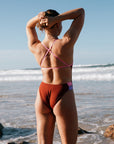 Athlete wearing the IBIZA chlorine resistant one piece designed by JAYD Swimwear. Featured colour is Cinnamon. Back strap detailing is adjustable to ensure even tension distribution across shoulders.
