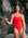 Ski paddler Jenaya Massie leaning against a rock at the beach wearing the JAYD Swimwear Airlie one piece swimsuit.