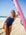 Surf life saving athlete Liv Corrin posing on the beach with her pink ski in the JAYD Swimwear navy Albi one piece.