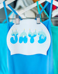 Swim Cap hanging on a rack with blue swimsuit