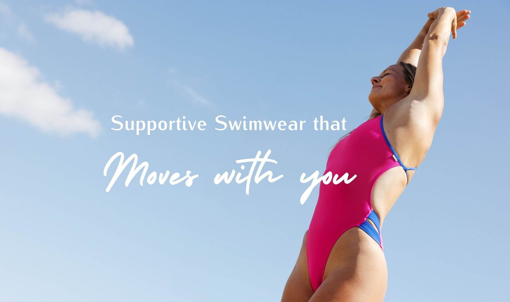 Woman in a pink swimsuit with blue accents against a clear blue sky, promoting supportive swimwear.