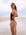 Surf Life Saving athlete Molly Shivnan standing on a beach wearing the JAYD Swimwear Lennox one piece swimuit in Cacao brown with contrasting blaze shoulder and hip straps.