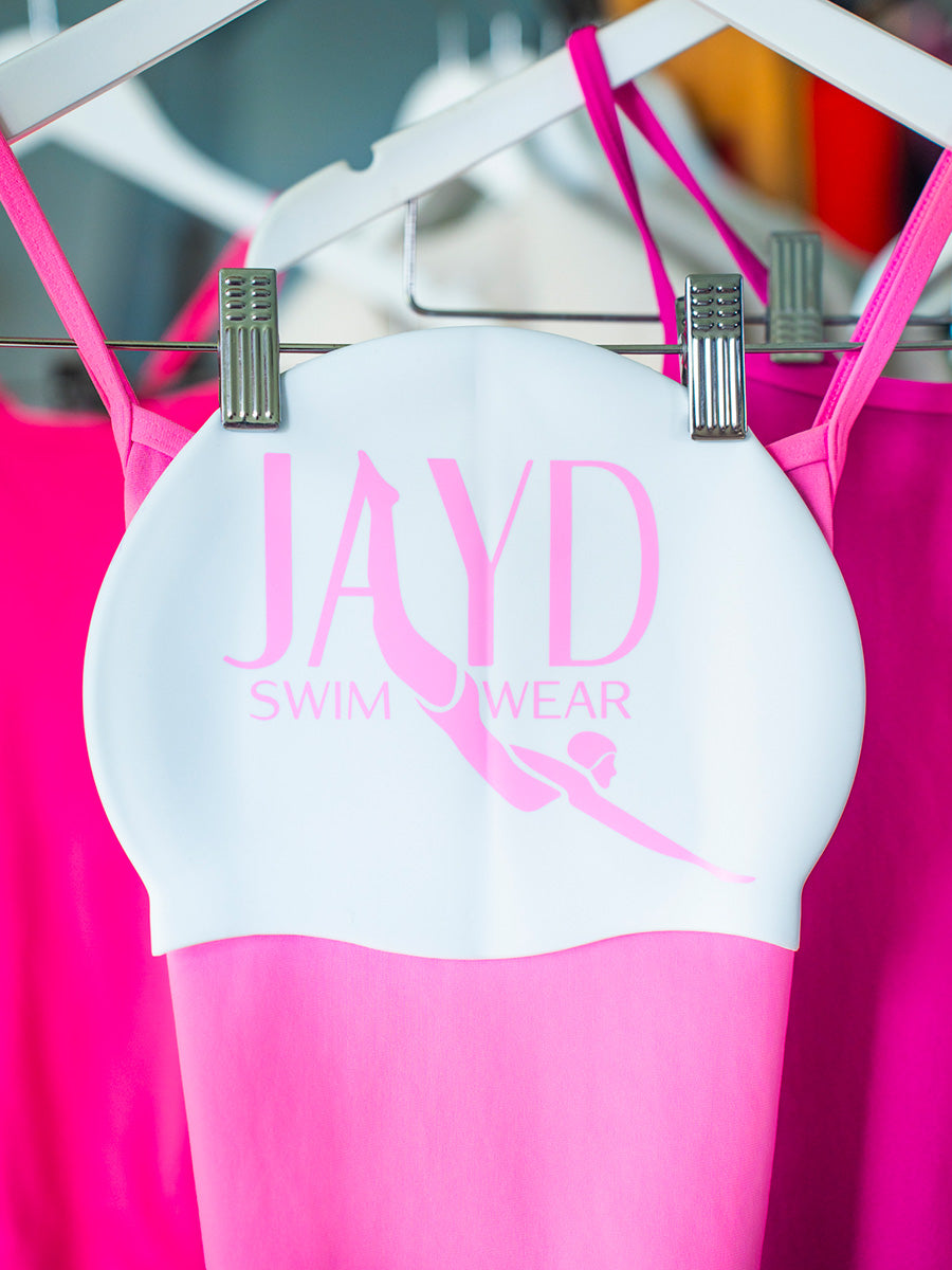 white swim cap with graphic of JAYD Swimwear text & woman diving