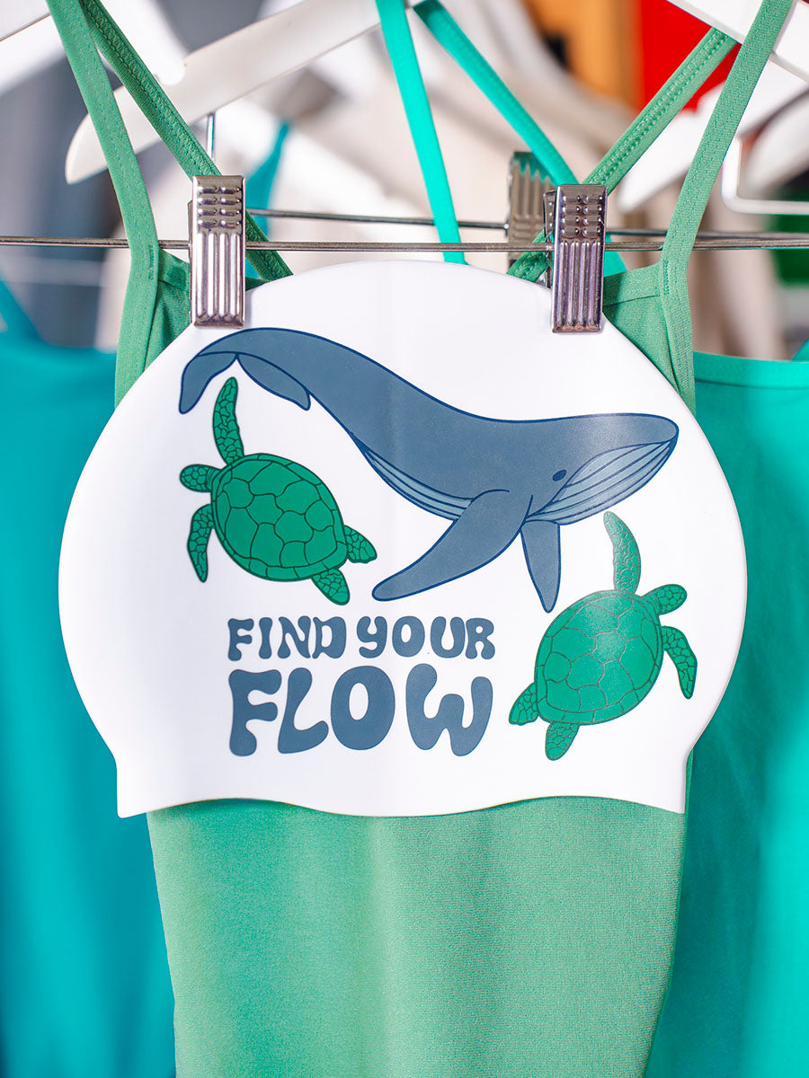 Swim cap design with whale and turtles and 'find your flow' text.