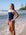 JAYD Swimwear athlete Cyra wearing the Finley one piece swimsuit in Navy with contrasting white shoulder straps.