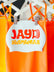 Orange swimwear with a 'JAYD Swimwear' label on a hanger.