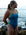 Model Kim standing on the beach gazing into the distance, wearing the JAYD Swimwear Ibiza one piece in nordic blue with contrasting moss green hip cut-outs and shoulder straps.