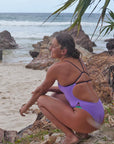 JAYD Swimwear's Zambia One Piece in Lilac Haze with Açaí contrasts worn by ironwoman Lucy Derbyshire, showcasing athletic fit and streamlined performance design.