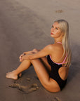 Athlete Keira wears the Airlie one piece by JAYD swimwear in the colour Acai. with contrasting Fairy Floss straps and back detailing. This piece was designed in Australia and will help you dive in with confidence.