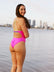 Athlete Jenaya wear a contrasting fixed back one piece called the Airlie. This piece is our fullest coverage and is made from chlorine resistant material. She is seen wearing the colour Pink Sorbet with contrasting Splice straps which are adjustable.