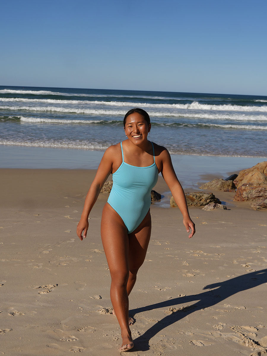 Surf Ironwoman Sara wears the Siena one piece designed by JAYD Swimwear, this one piece is fixed back and made with chlorine resistant material. It is built for performance.