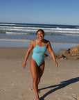 Surf Ironwoman Sara wears the Siena one piece designed by JAYD Swimwear, this one piece is fixed back and made with chlorine resistant material. It is built for performance.