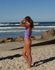 Athlete Molly wears the Siena fixed-back one piece by JAYD swimwear  in the colour Lilac Haze. This piece offers mid-coverage and is perfect for swim training.