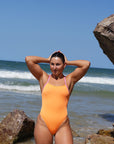 JAYD Swimwear swimmer Madi, wears the fixed back Lennox one piece in the colour Sunshine, this piece has contrasting Fairy Floss straps