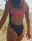 Back view of Zambia One Piece Athletic Swimsuit in Black & Pink Sorbet by JAYD Swimwear