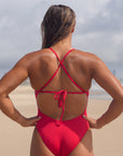 Back view of JAYD Swimwear full coverage tie back athletic one piece: Riva in Ruby 