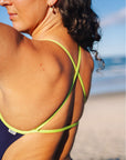 Detailing of Kiwi coloured straps on the ibiza one piece in the colour Acai. Designed in collaboration of JAYD swimwear and open water swimmer Madi Armstrong