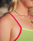Detailing of JAYD Swimwear's active one piece in the style Zambia. Image shows the Kiwi colour with the contrasting Tart shoulder strap.