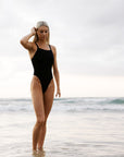 Athlete Keira wears her fixed back one piece called Soraya designed by JAYD Swimwear to the beach, as they design flattering and functional suits.