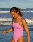 JAYD Swimwear, athletic one piece called Tallow in the colour Fairy Floss, lifestyle image at the beach.