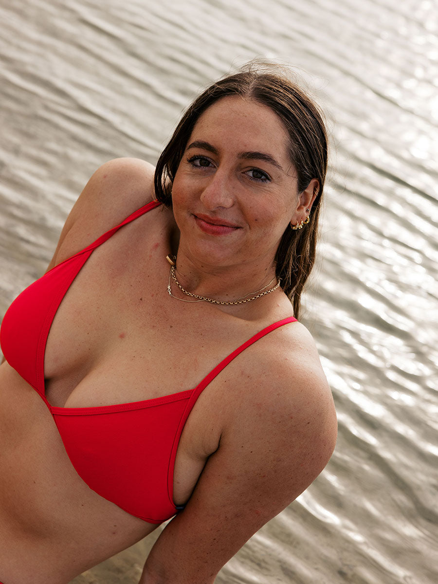 Athlete Jenaya wears the Triangle tie-back top by JAYD Swimwear in the colour Ruby. Top is made from chlorine resistant material.