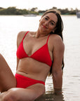 Athlete Jenaya wears the triangle tie-back top by JAYD Swimwear in the colour Ruby. This piece is built for both performance and leisure.