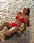 Athlete Jenaya wears the Triangle top by JAYD Swimwear in the colour Ruby. This top is adjustable and perfect for swim training.