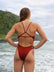 Back view of model wearing JAYD Swimwear Lennox one piece swimsuit in Cinnamon.