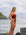 Side shot of model on a rock wearing JAYD Swimwear Isla tie-back one piece in Cinnamon.