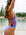 Side view of model on beach wearing JAYD Swimwear athletic one piece Lennox in Lilac Haze.