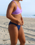 Side view of seamless, athletic, full coverage JAYD Swimwear Cali bikini bottoms in Navy blue.