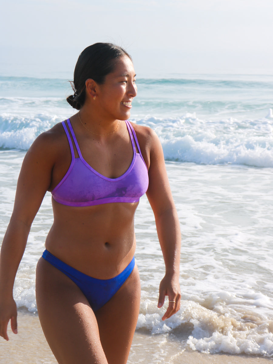 Side view of seamless, athletic, cheeky coverage JAYD Swimwear Minnie bikini bottoms in Cobalt Blue.