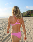 Back view of seamless, athletic, cheeky coverage JAYD Swimwear Minnie bikini bottoms in Fairy Floss pink.