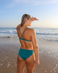 Back view of seamless, athletic, full coverage JAYD Swimwear Cali bikini bottoms in Cove green.