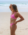 Side view of JAYD Swimwear Cali athletic bikini bottoms in Fairy Floss Pink.