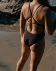 Athlete Soraya wears the Tallow fixed back one piece by JAYD Swimwear in the colour Cacao. Tallow offers tension distributing straps.