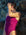 Side view of model leaning against a rock wearing JAYD Swimwear athletic tie-back one piece Riva in Sangria.