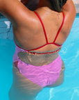 Back strap view of Zambia One Piece Athletic Swimsuit in Fairy Floss Pink with Ruby contrast cutouts, by JAYD Swimwear.