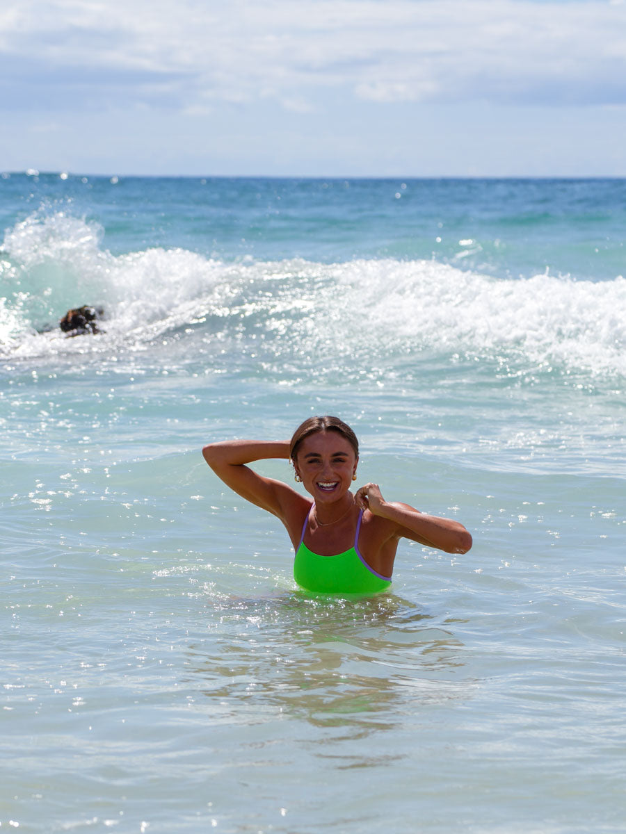 Ocean view of Zambia One Piece Athletic Swimsuit in Splice green by JAYD Swimwear