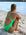 Rear seated view of JAYD Swimwear's full-coverage athletic one-piece Tallow in Meadow.