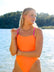 Front view of model on beach wearing JAYD Swimwear athletic one piece Zambia in Neon Orange.