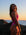 Side view of model on a beach at sunrise wearing JAYD Swimwear athletic one piece swimsuit Zambia in Orchid Pink.
