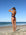 Back view of model on sand wearing JAYD Swimwear cheeky one piece Zimmy in Acai.