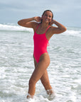 Front view of JAYD Swimwear tie back athletic one piece: Isla in Fiesta Pink