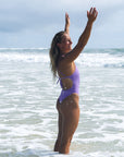 Side view of JAYD Swimwear tie back athletic one piece: Isla in Lilac Haze