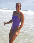 Side front view of JAYD Swimwear tie back athletic one piece: Isla in Lilac Haze