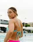 Side view of JAYD Swimwear athletic training bikini top, Triangle, in Mykonos Blue.