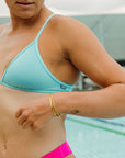 Side view of JAYD Swimwear athletic training bikini top, Triangle, in Mykonos Blue.